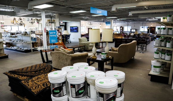 ReStore show floor at New Brighton showing couches, lamps, and gallons of paint.