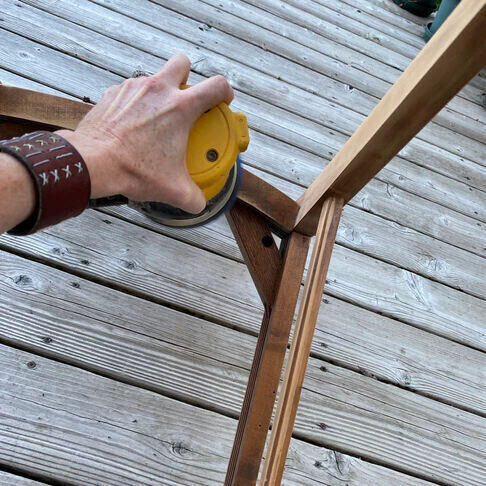 Rae sanding the chair.