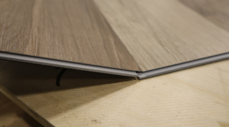 Close-up of two vinyl planks snapping together.