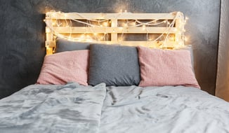 DIY Headboard with string lights, made out of a wood pallet.