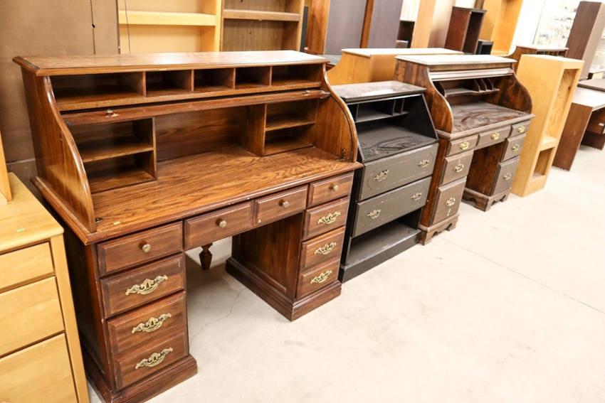 Office desks lined up in a showroom.