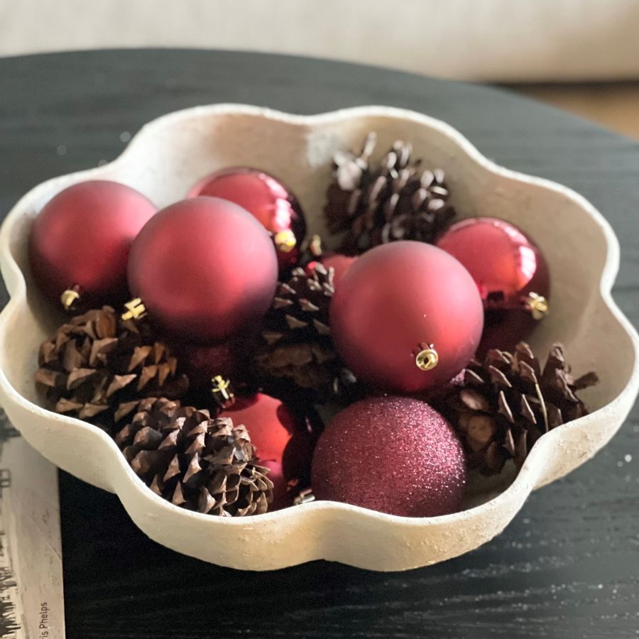 Bowl with pinecones and ornaments.
