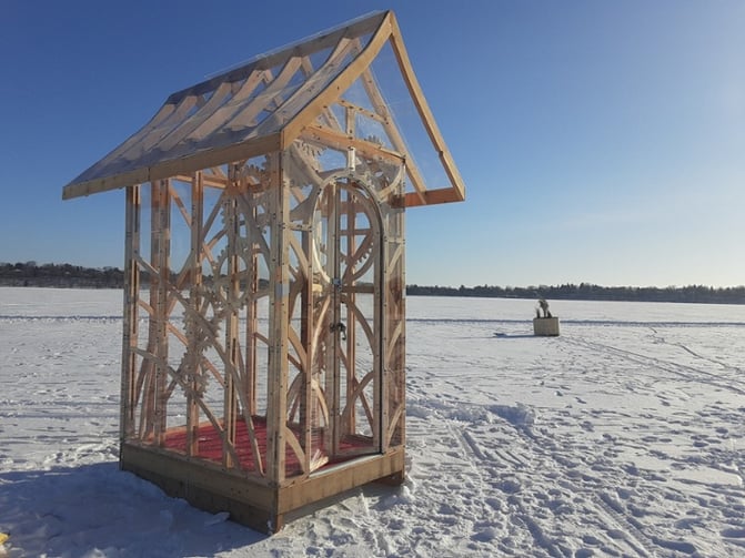 Artistic ice house shanty on a frozen lake