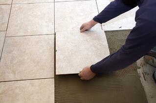 Laying tile for a new floor.
