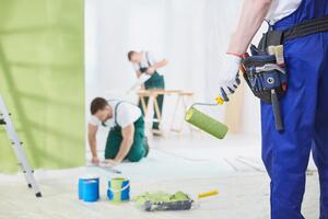 A group of men remodeling a room.