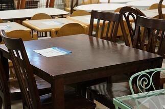 Dark wood square table with chairs.