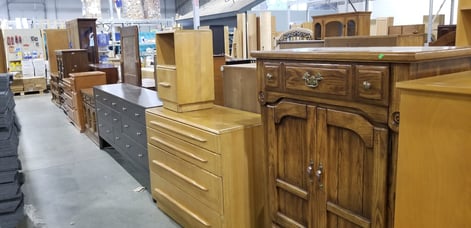 Assortment of cabinets and desks on the showroom floor.