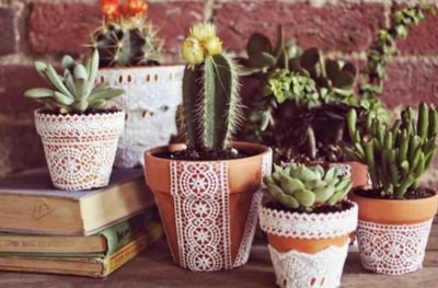 Set of terra cotta pots decorated with lace.