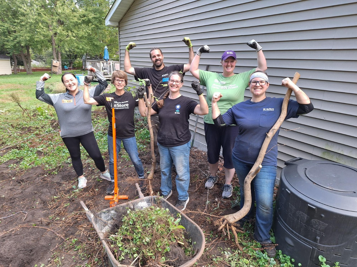 ReStore group flexing their arms.