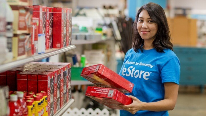 Person holding items at ReStore.