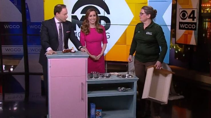 Jan showing a pink playset that used to be an entertainment center.