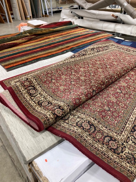 Two rugs - one floral and one striped, both in warm earth tones..