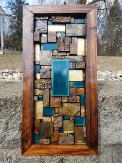 Wooden framed art with blue tiles.