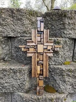 Wooden cross made out of tiles.