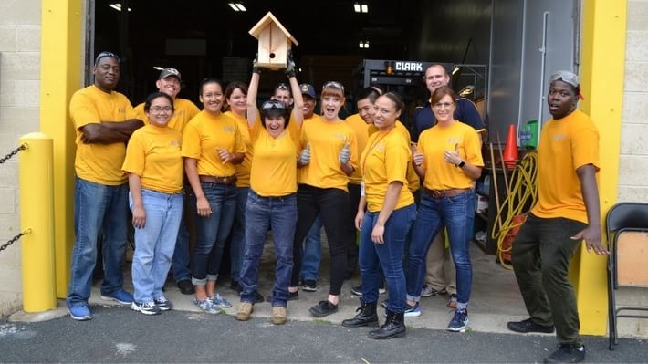 Navy volunteers with a finished birdhouse.