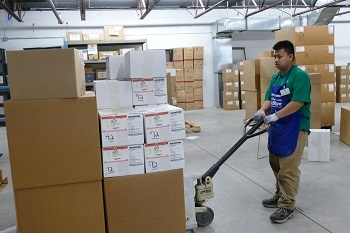 Keng moving boxes with a pallet jack.