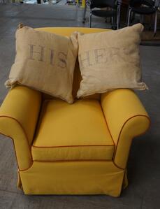 A yellow chair and pillows.