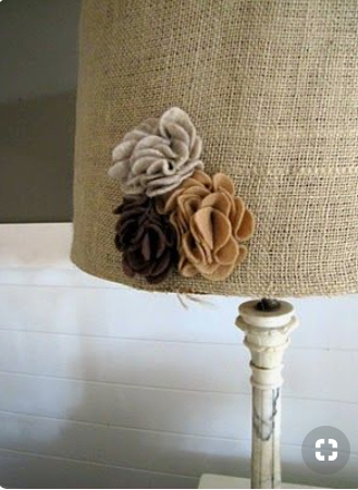 Lamp shade decorated with burlap and flowers.