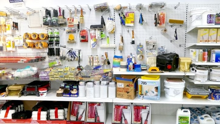 A wall of paint supplies, tape rolls, and other small hardware items.