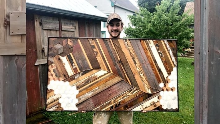 Joey holding one of his art pieces.