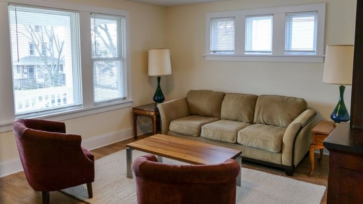 Living room with chairs, coffee table, end tables, and lamps.