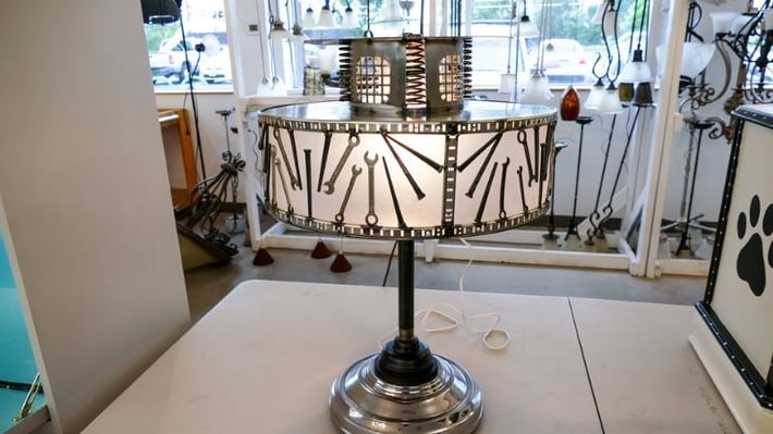 Upcycled lamp with metal designs.