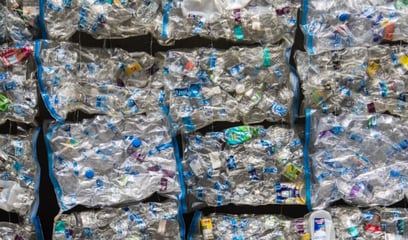 Overhead view of thousands of compressed plastic bottles