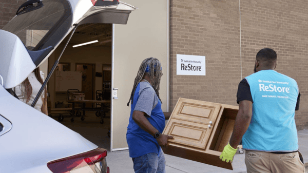 People carrying a small table.