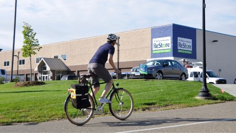 A cyclist passing the ReStore.