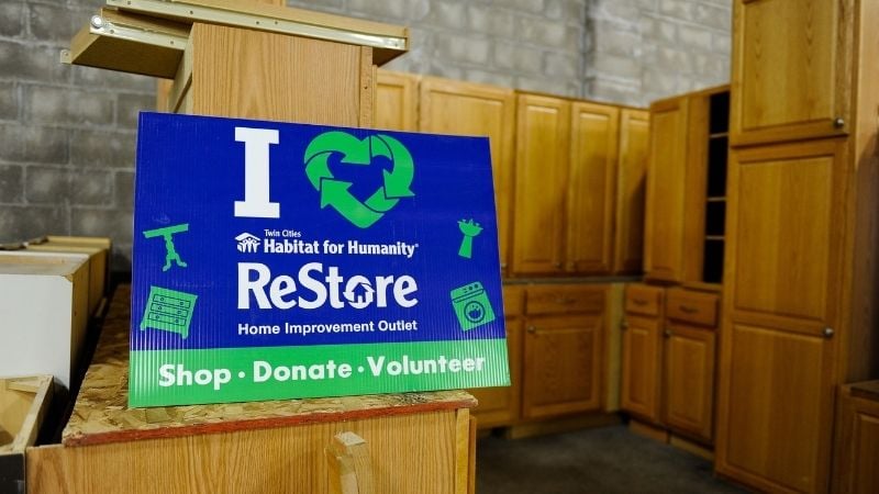I heart ReStore sign with cabinets.