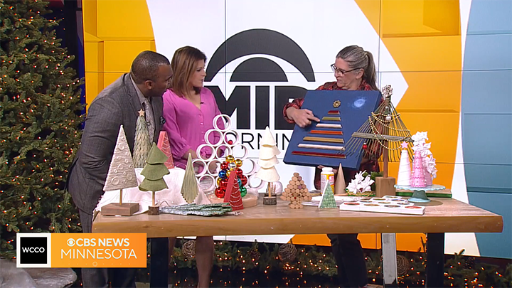 Jan at the WCCO studio with a variety of DIY Christmas trees.