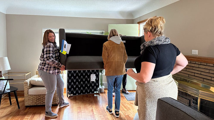 RESA members moving furniture into house.