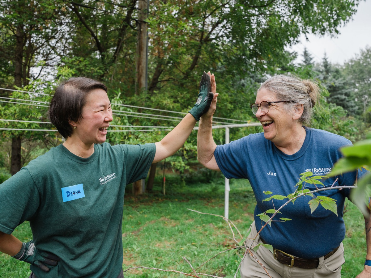 ReStore employees giving a high five.