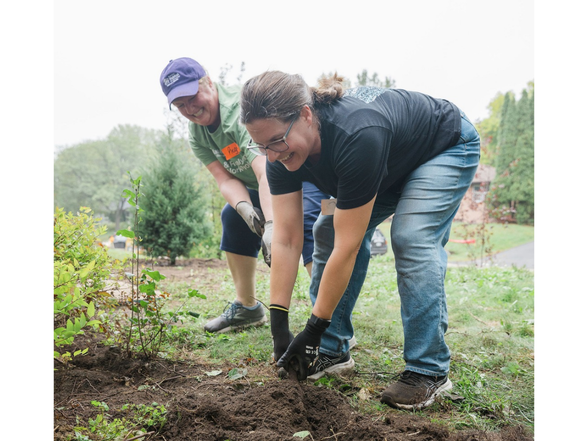 Two ReStore employees pulling up roots.