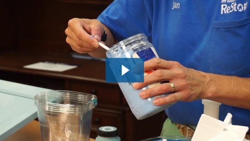 A video preview image of Jan mixing paint.