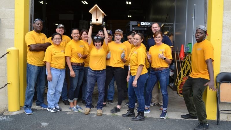Navy volunteers with a finished birdhouse.