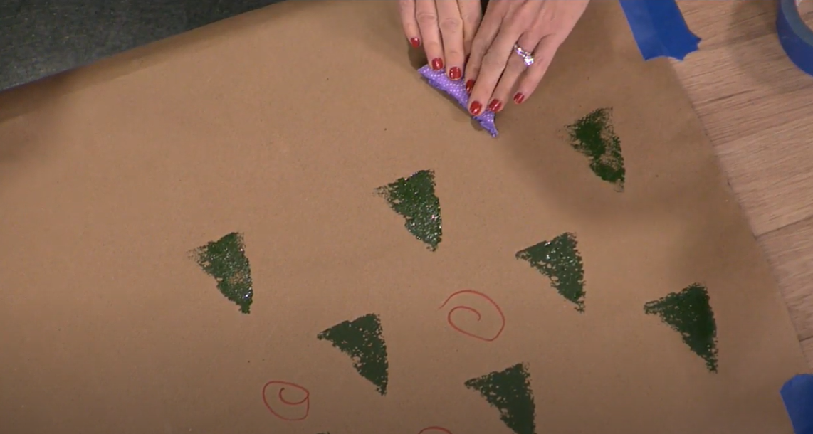 Decorating kraft paper with a tree-shaped sponge and paint